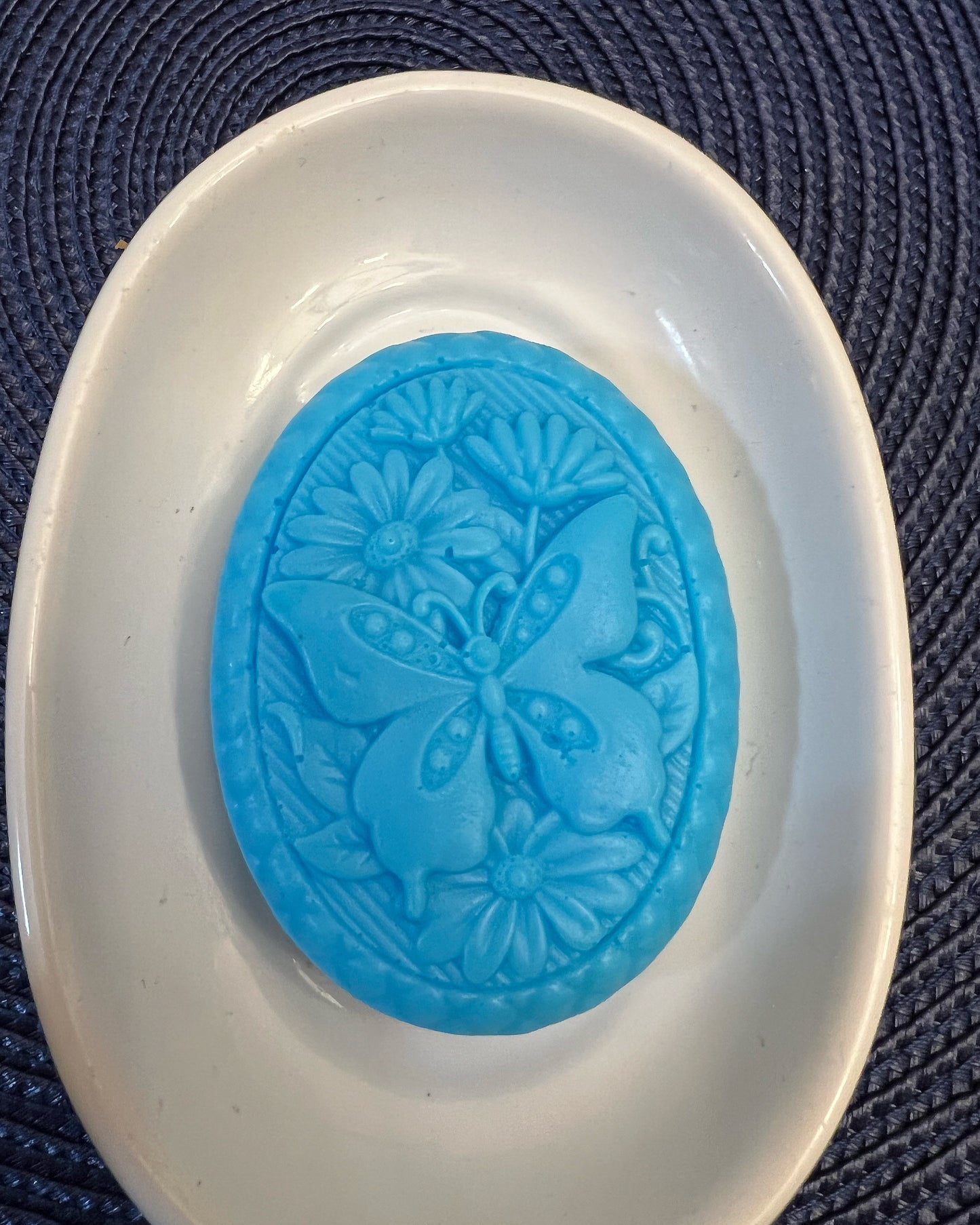 Butterfly among flowers (oval)